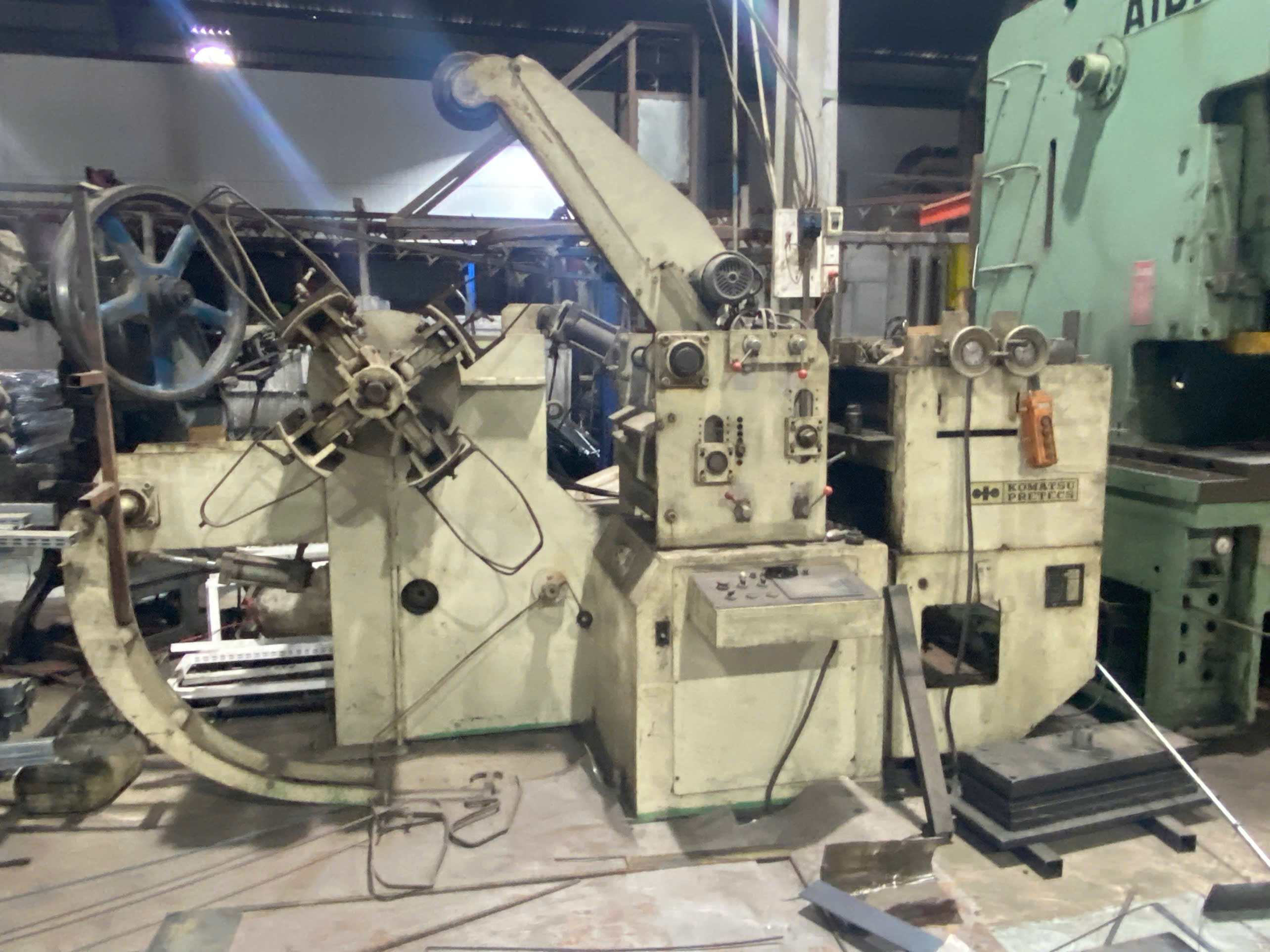 Automatic steel stamping and coiling machine